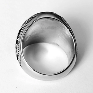 Detailed close-up of the textured silver band and smooth brushed metal interior of the ring