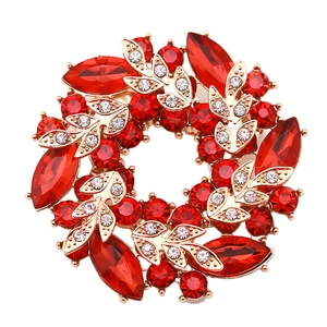 Fashionable round acrylic and gold alloy brooch featuring red rhinestones and crystal leaves