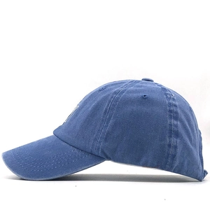 Detail of blue washed cotton baseball cap with vintage distressed texture and stitching