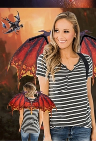 Detail of red dragon wings prop showing vibrant flame texture and secure shoulder straps