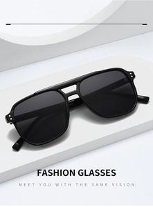 Detail of black aviator sunglasses featuring double bridge and gold rivet accents