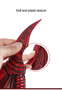 Detail showing soft and elastic texture of dragon wing costume accessories via hand pressure