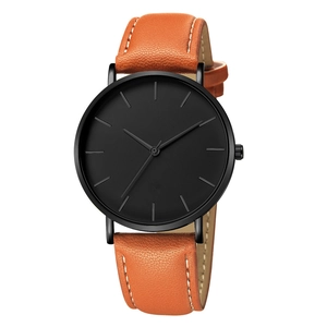 Minimalist business watch with sleek black dial and vibrant orange leather strap detail