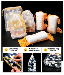 Close-up of frosted daisy drawstring storage bags with orange ropes for travel organizing