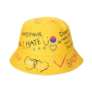 Detail of yellow cotton bucket hat featuring black graffiti letters and street style print
