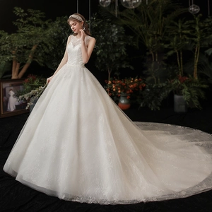 Elegant white ball gown wedding dress with illusion lace neckline and long sequin train