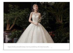Detail of elegant white floral lace bodice with illusion neckline on a bridal gown