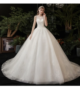 Detail of sheer lace neckline and intricate embroidery on white ball gown bridal dress