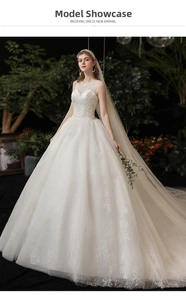 Detailed view of white lace embroidery wedding dress with sparkling sequin train and veil