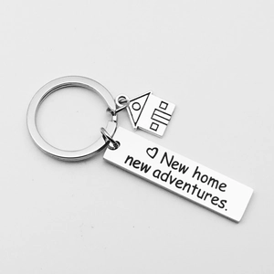 Macro shot of silver stainless steel keychain with New Home New Adventures engraving