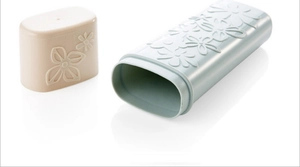 Portable blue floral embossed travel toothbrush case with separate lid on white surface
