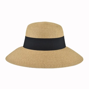Detailed view of woven straw sun hat texture with black ribbon bow on white background