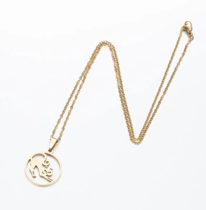 Close-up of golden stainless steel necklace with laser cut hollow cat pendant detail