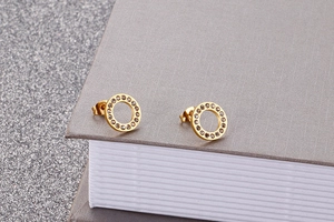 Close-up of rose gold circle stud earrings featuring micro-set sparkling crystals