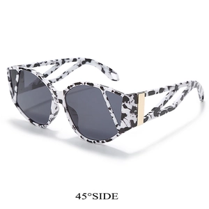 Detailed 45-degree side view of cat-eye sunglasses with spotted frames and metal accents