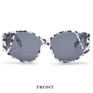 Front view of cat-eye sunglasses with black and white marble pattern frames and dark lenses