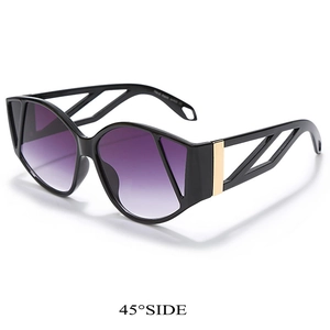 Detail of cat eye sunglasses with purple gradient lenses and gold geometric temple design
