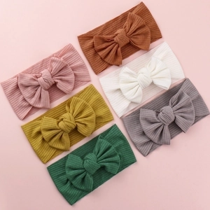 Set of six soft knitted baby headbands with large bows in diverse neutral earth tones