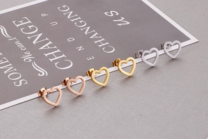 Detailed view of hollow heart earrings in rose gold, gold, and silver finishes