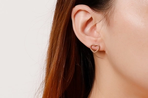 Rose gold hollow heart-shaped stud earring shown on model ear for elegant daily style