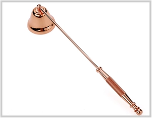 Elegant rose gold metal candle snuffer with a long handle and bell head on white background