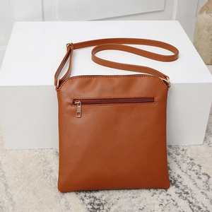 Caramel brown square crossbody bag with back zipper pocket and golden hardware details