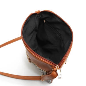 Detail view of the leopard print crossbody bag showing inner pocket and gold zipper
