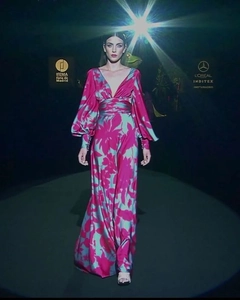 Detail of V-neck floral maxi dress with puff sleeves and buttoned cuffs on runway