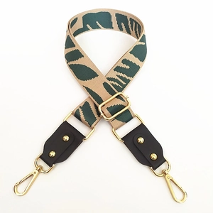 Adjustable wide canvas shoulder strap with green leaf pattern and golden metal clips