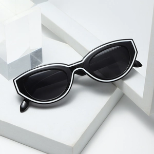 Retro cat eye sunglasses with black frame and white outlines on geometric props