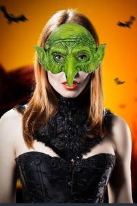 Detailed texture of green latex witch mask with hooked nose and pointy goblin ears