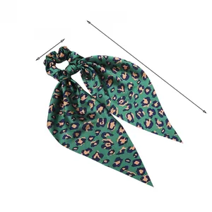 Detail of leopard print satin hair scrunchie with long ribbon showing size dimensions