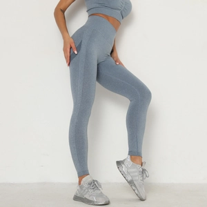 Detail of high-waisted seamless yoga pants with textured blue knit and side stripes