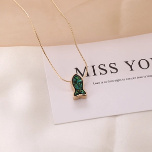 Golden mermaid tail necklace with green and blue stones on a Miss You gift card
