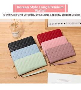 Detail of multi-color long zip wallets with quilted pattern and wrist straps