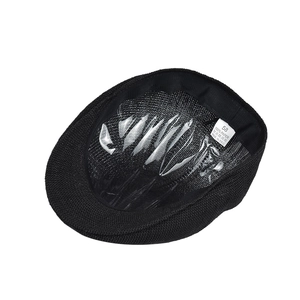 Detail view of the black paper mesh beret interior with size 58 label and woven texture