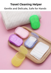 Five assorted colors of portable soap paper boxes on a tray for travel hygiene