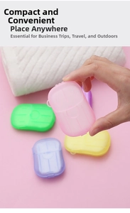 Handheld view of portable soap paper containers in four colors for travel hand washing