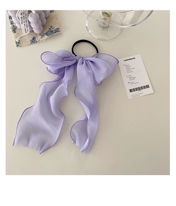 Detail of light purple oversized bow hair tie with delicate lace chiffon texture