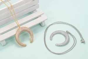 Elegant gold and silver crescent moon pendant necklaces with shimmering cubic zirconia