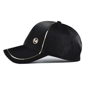Elegant black satin-textured baseball cap with golden M logo and metallic trim accents