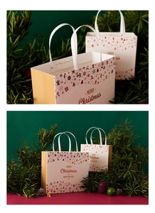 Close-up of vintage Christmas paper gift bags with reindeer patterns and white ribbon handles