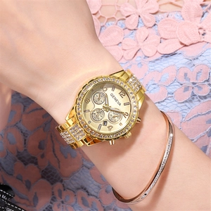 Close-up of luxury gold Geneva quartz watch with rhinestones and matching gold bracelet