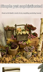 Detail of vintage artificial roses in rustic wooden boxes and baskets with fallen leaves
