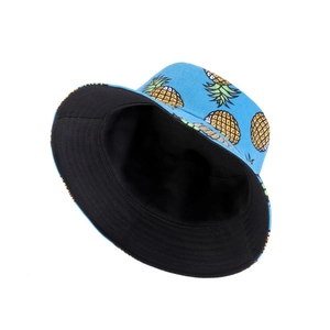 Blue reversible cotton bucket hat with yellow pineapple prints for summer sun protection