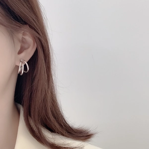 Close-up of minimalist S925 sterling silver multilayered hoop earrings on model