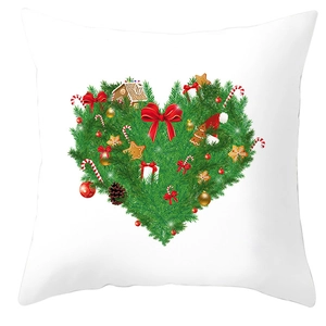 White Christmas pillow cover with heart-shaped holiday wreath featuring gingerbread man