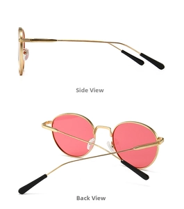 Detail view of round metal sunglasses with pink lenses from side and back angles
