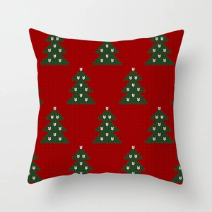 Detail of red Christmas pillowcase featuring green knitted-style tree patterns