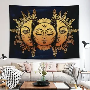 Detail of bohemian sun and moon tapestry hanging above a modern living room sofa